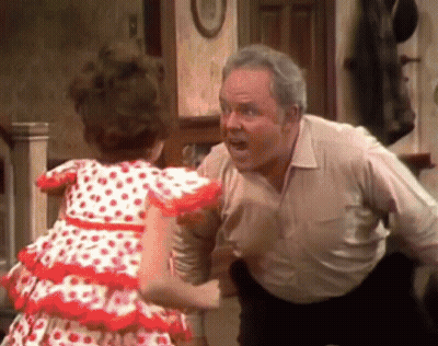 A Little Girl In A Red And White Polka Dot Dress Is Standing Next To A Man In A White Shirt . GIF