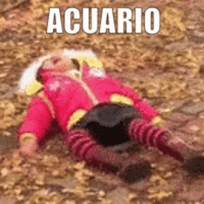A Little Girl In A Red Jacket Is Laying On The Ground With The Word Acuario Above Her . GIF