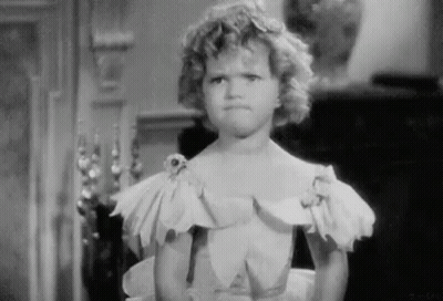 A Little Girl In A White Dress Is Making A Funny Face . GIF