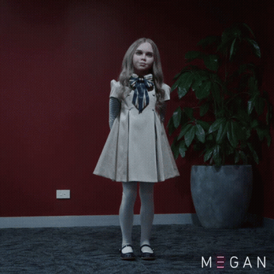 A Little Girl In A White Dress Stands In Front Of A Potted Plant With Megan Written On The Bottom Right GIF