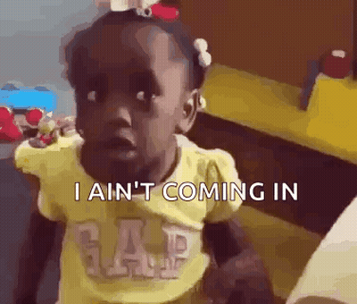 A Little Girl In A Yellow Gap Shirt Is Making A Funny Face And Saying I Ain 'T Coming In . GIF