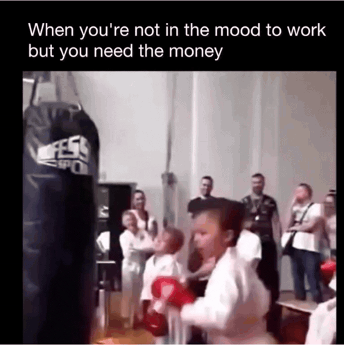 A Little Girl Is Boxing In Front Of A Punching Bag GIF