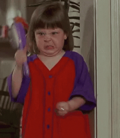 A Little Girl Is Brushing Her Hair With A Purple Brush . GIF