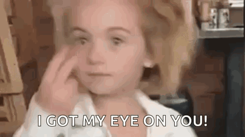 A Little Girl Is Covering Her Face With Her Hand And Says `` I Got My Eye On You '' . GIF