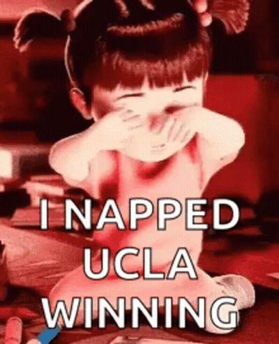 A Little Girl Is Covering Her Face With Her Hands And The Words I Napped Ucla Winning GIF