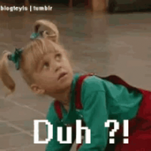A Little Girl Is Crawling On The Floor With The Words Duh ? Written On Her Face . GIF