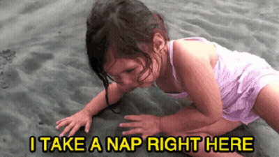 A Little Girl Is Crawling On The Sand With The Words " I Take A Nap Right Here " Below Her GIF