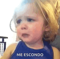 A Little Girl Is Crying And Making A Funny Face While Wearing A Blue Tank Top . GIF