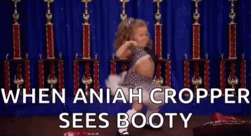 A Little Girl Is Dancing In Front Of Trophies With The Words `` When Aniah Cropper Sees Booty '' . GIF