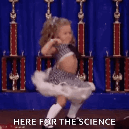 A Little Girl Is Dancing On A Stage In Front Of Trophies And The Words Here For The Science . GIF