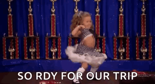 A Little Girl Is Dancing On A Stage In Front Of Trophies And The Words `` So Rdy For Our Trip '' . GIF