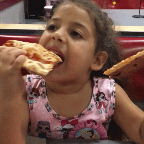 A Little Girl Is Eating A Slice Of Pizza And Wearing A Lol Surprise Shirt GIF