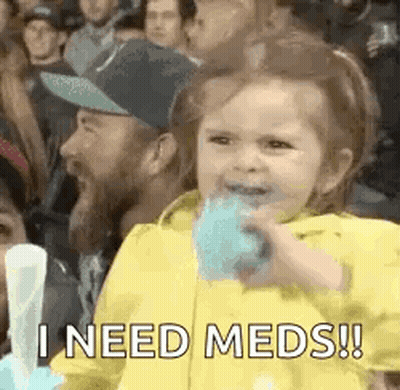 A Little Girl Is Eating Cotton Candy In A Crowd While A Man Looks On . GIF
