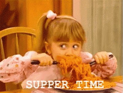 A Little Girl Is Eating Spaghetti With The Words Supper Time Written On The Bottom Right GIF