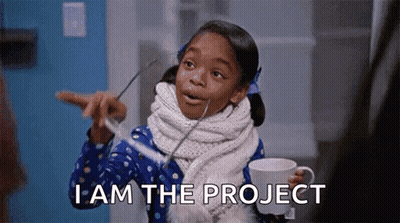 A Little Girl Is Holding A Cup Of Coffee And Pointing At Something While Saying I Am The Project . GIF