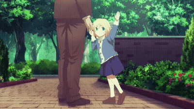 A Little Girl Is Holding A Man 'S Hand While Standing On A Brick Sidewalk GIF