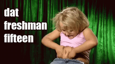 A Little Girl Is Holding Her Belly With The Words " Dat Freshman Fifteen " Above Her GIF