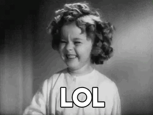 A Little Girl Is Laughing In A Black And White Photo With The Word Lol On Her Face . GIF