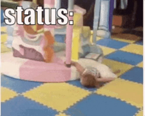 A Little Girl Is Laying On The Floor In A Playground With The Words Status Written Above Her GIF