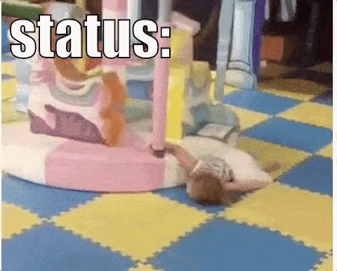A Little Girl Is Laying On The Floor In A Playground With The Words Status Written On The Bottom GIF