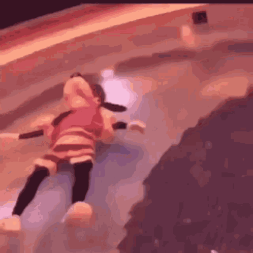 A Little Girl Is Laying On The Floor In A Pool . GIF