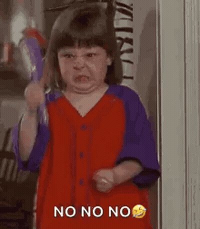 A Little Girl Is Making A Funny Face While Holding A Broom And Making A Funny Face . GIF