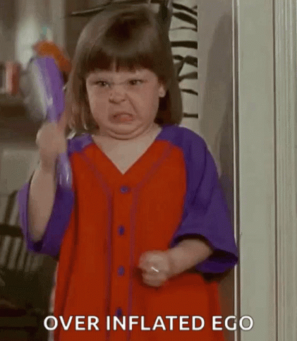 A Little Girl Is Making A Funny Face While Holding A Toothbrush . GIF