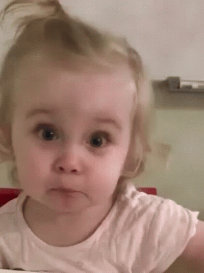 A Little Girl Is Making A Funny Face While Looking At The Camera . GIF
