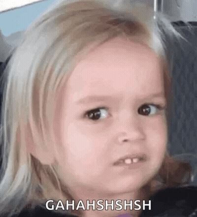 A Little Girl Is Making A Funny Face While Sitting In A Car Seat . GIF