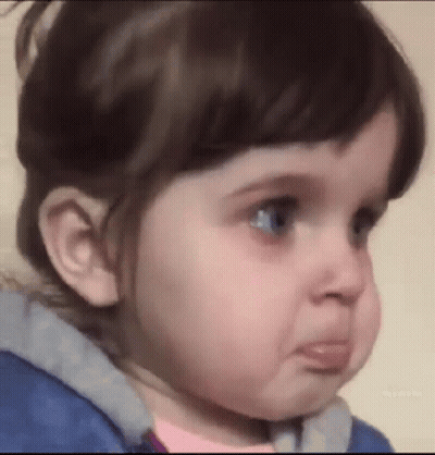 A Little Girl Is Making A Funny Face With Her Mouth Open . GIF