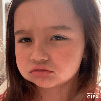 A Little Girl Is Making A Sad Face With A Gifx Watermark GIF