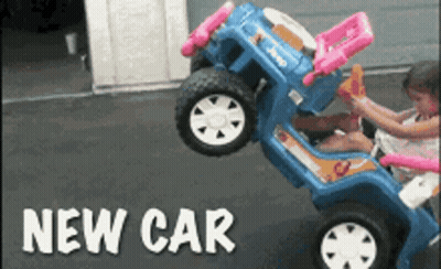 A Little Girl Is Playing With A Toy Car That Says Jeep GIF