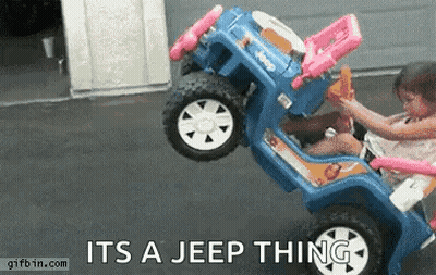 A Little Girl Is Riding A Blue Toy Jeep With The Words " It 'S A Jeep Thing " On The Bottom GIF