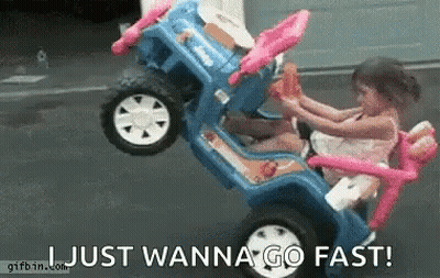 A Little Girl Is Riding A Toy Car With The Words Just Wanna Go Fast Written Below Her . GIF