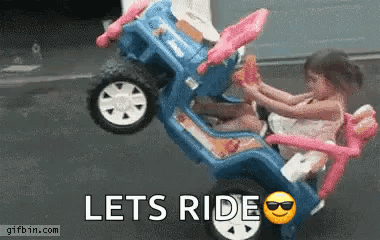 A Little Girl Is Riding On The Back Of A Toy Car With The Words Lets Ride Below Her GIF
