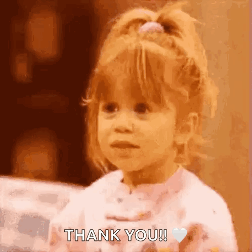 A Little Girl Is Saying Thank You With A Heart In Her Hand . GIF