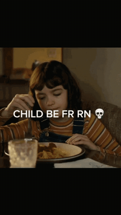 A Little Girl Is Sitting At A Table With A Plate Of Food And The Words Child Be Fr Rn GIF