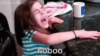 A Little Girl Is Sitting At A Table With Her Arms Outstretched And Says Nooo . GIF