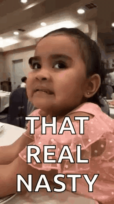 A Little Girl Is Sitting At A Table With The Words `` That Real Nasty '' On Her Face . GIF
