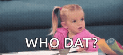 A Little Girl Is Sitting At A Table With The Words `` Who Dat '' Written Above Her . GIF