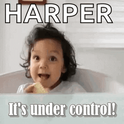 A Little Girl Is Sitting In A Bathtub Eating A Piece Of Food And Making A Face . GIF