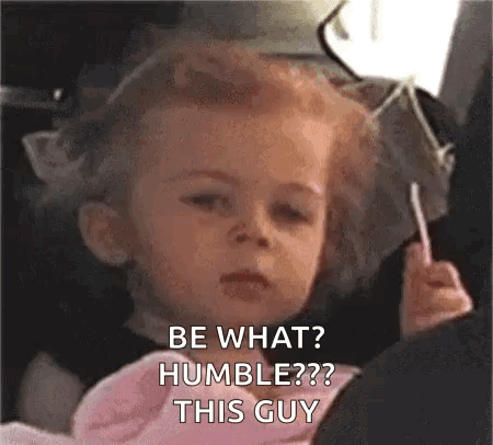 A Little Girl Is Sitting In A Car Seat Holding A Lollipop And Making A Face . GIF
