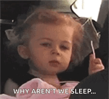 A Little Girl Is Sitting In A Car Seat Holding A Lollipop And Saying `` Why Aren 'T We Sleep . '' GIF
