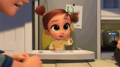 A Little Girl Is Sitting In A High Chair And Looking At Something GIF
