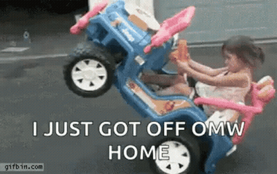 A Little Girl Is Sitting In A Toy Car With A Monkey . GIF