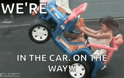 A Little Girl Is Sitting In A Toy Car With The Words We 'Re In The Car On The Way GIF