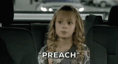 A Little Girl Is Sitting In The Back Seat Of A Car Talking . GIF