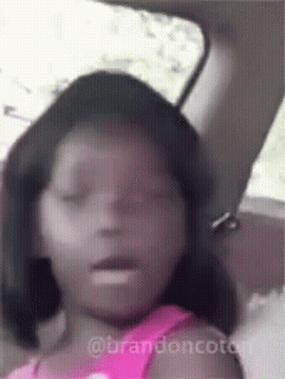 A Little Girl Is Sitting In The Back Seat Of A Car With Her Eyes Closed And Her Mouth Open . GIF
