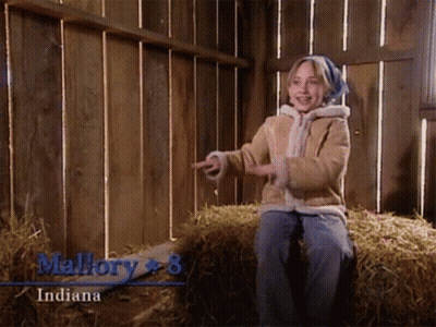 A Little Girl Is Sitting On A Bale Of Hay And The Name Mallory Is On The Bottom GIF