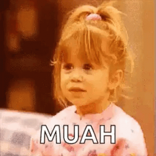 A Little Girl Is Sitting On A Bed And Making A Funny Face While Wearing Pajamas . GIF